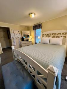 a bedroom with a large white bed in a room at The Ludington House in Ludington