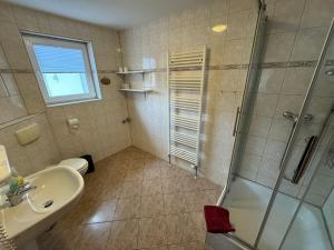 a bathroom with a shower and a sink at Hotel garni SEESCHLÖSSCHEN in Kölpinsee +204 photos