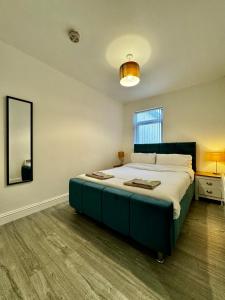 a bedroom with a large bed and a mirror at Rooms Near Me - Apartment 2, Smart Tv, Free Parking in Halesowen