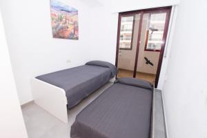 A bed or beds in a room at Edificio Calpeplaya