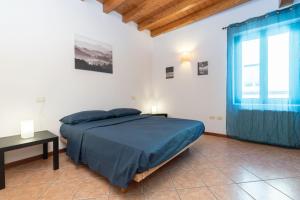 a bedroom with a bed and a table and a window at JAM Apartments in Malcesine