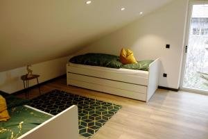 a attic room with a bed and a window at Ferienwohnung Haus Kampen in Aschau im Chiemgau