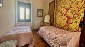 a bedroom with two beds and a mirror at La Cristina in Berástegui