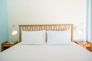 A bed or beds in a room at Iris Villas Lefkada - Karavi Villa with private sea access
