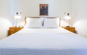 A bed or beds in a room at Iris Villas Lefkada - Karavi Villa with private sea access