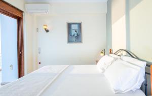 A bed or beds in a room at Iris Villas Lefkada - Karavi Villa with private sea access