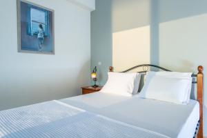 A bed or beds in a room at Iris Villas Lefkada - Karavi Villa with private sea access
