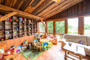 a living room filled with lots of toys at Siedlisko Pod Dębem in Wilimy