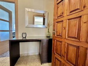 a room with a desk with a mirror and a door at Los Girasoles - 6806 in Noja +28 photos