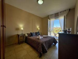 a bedroom with a bed and a large window at Los Girasoles - 6806 in Noja