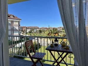 a balcony with a table and a view of a city at Los Girasoles - 6806 in Noja