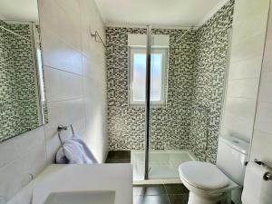 a bathroom with a shower and a toilet and a sink at La Esteluca - 6805 in Noja +24 photos
