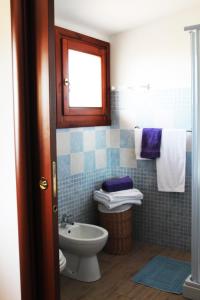 a bathroom with a toilet and a sink at B&B L'alba Nel Golfo in Castelsardo