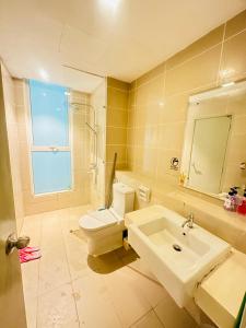 a bathroom with a toilet and a sink at Sutera Luxurious Loft 1 in Kota Kinabalu