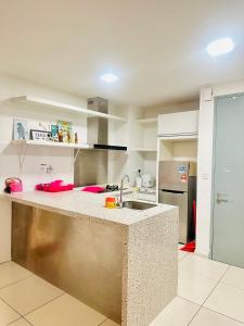 a kitchen with a sink and a counter top at Sutera Luxurious Loft 1 in Kota Kinabalu