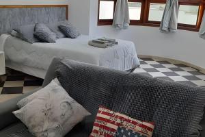 a bedroom with two beds and a checkered floor at Mansão Adalgisa in Osasco