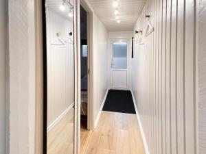 a hallway with white walls and a glass door at 6 person holiday home in Hemmet in Falen