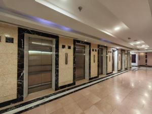 a row of elevators in a hotel lobby at فندق ميزاب العدل مكة in Makkah