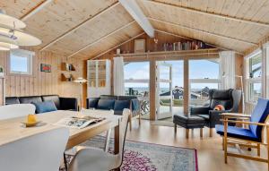 a living room with a table and chairs and a couch at Stunning Home In Sjølund With Kitchen in Sjølund