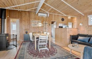 a living room with a table and a couch at Stunning Home In Sjølund With Kitchen in Sjølund