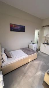 a bedroom with a bed with a tv on the wall at Serene Stay in Vlorë