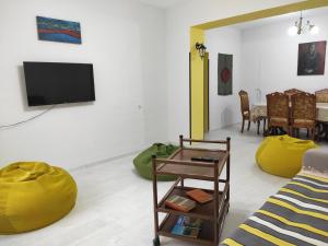 a living room with a couch and a yellow bean bag chair at Ners Guest House in Gyumri