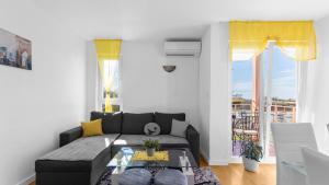 a living room with a couch and a table at Apartment Sana with Sea View in Novigrad Istria