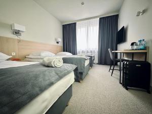 Posteľ alebo postele v izbe v ubytovaní Hotel Turkus