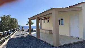 a small house on the beach next to the ocean at Sfinias Apartments in Kaloi Limenes