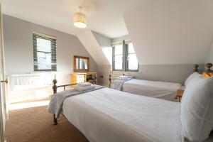 a bedroom with two beds and two windows at Escape Ordinary at Lough Erne GV - No.32 in Enniskillen