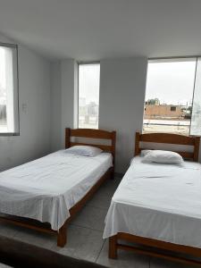 Postel nebo postele na pokoji v ubytování YOLO House Peru