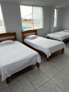 Postel nebo postele na pokoji v ubytování YOLO House Peru