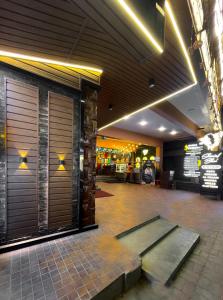 a lobby with two garage doors in a building at Shree Residency in Erode