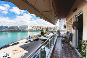 a balcony with a view of a river and a city at Debbies διαμέρισμα δίπλα στο νερό #2 ! in Chalkida