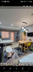 a living room with a table and a couch at THE FIKA ROOM near MNL Airport - Scandi Studio Unit with Fast Wi-Fi & Netflix - Read Full Property Desc before booking in Manila