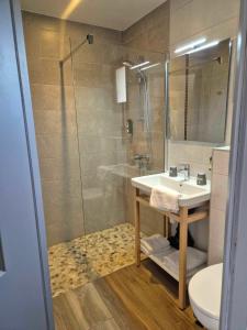 a bathroom with a shower and a sink and a toilet at Logis Le Mistral - Montélimar Sud in Châteauneuf-du-Rhône