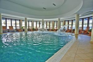 a large pool with a fountain in a building at Termag Hotel Jahorina in Jahorina