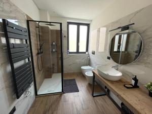 a bathroom with a shower and a sink and a toilet at Industrial House 3 in Corsico