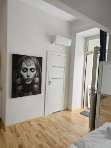 a room with a picture of a woman on the wall at Juwel Apartments Kraków 14 in Kraków