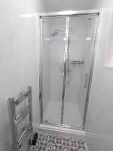 a shower with a glass door in a bathroom at Centra Station in London