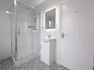 a white bathroom with a shower and a sink at Centra Station in London