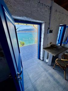 an open door to a room with a view of the ocean at Rocksecret Edge in Kalamata