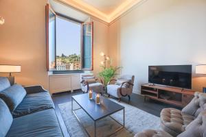 a living room with a couch and a tv at Apartments Florence- Palazzo Benci with river view · Palazzo Benci with river view in Florence