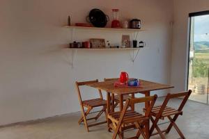 uma mesa de madeira e cadeiras num quarto em Sítio Âmbar - Família, tranquilidade e privacidade em Lambari