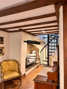 a living room with a stone fireplace and a chair at Rose Tor Hotel in Llandudno