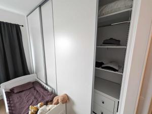 a white closet with a bed in it at Central apartment with a view in Växjö