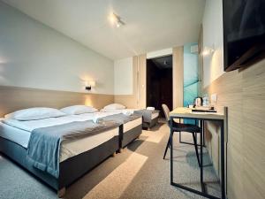 Posteľ alebo postele v izbe v ubytovaní Hotel Turkus