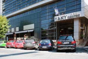 a row of cars parked in front of a building at Hotel Yaky Center in Piteşti