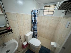 a bathroom with a toilet and a shower and a sink at Condo in Pasig - One Oasis Staycation in Manila +4 photos