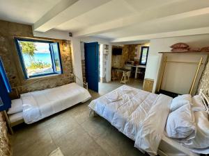 a bedroom with a large bed and a window at Rocksecret Edge in Kalamata